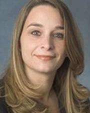 Woman with blonde hair wearing a dark shirt.